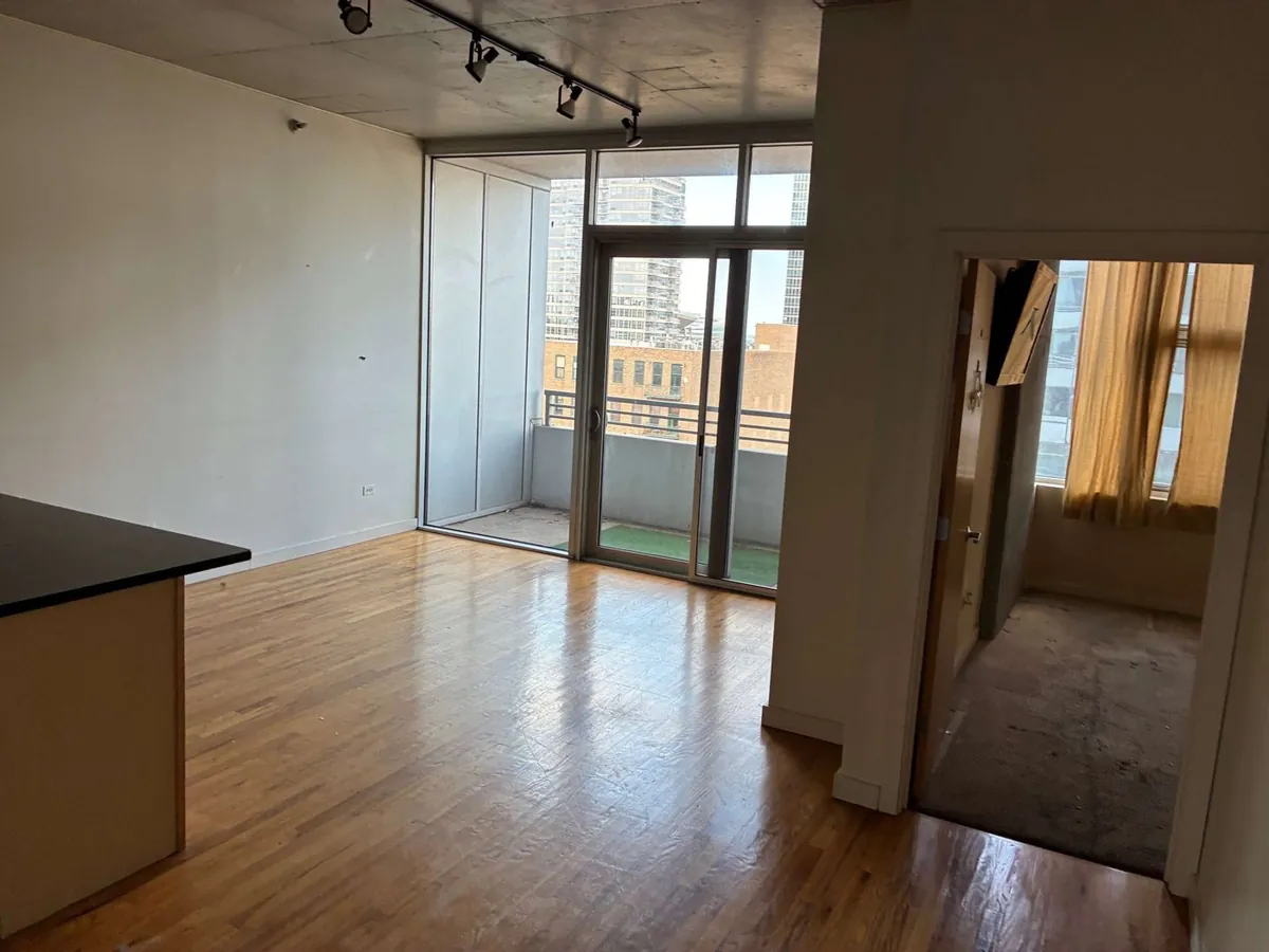 After: the same living room, empty (condo cleanouts, South Loop)