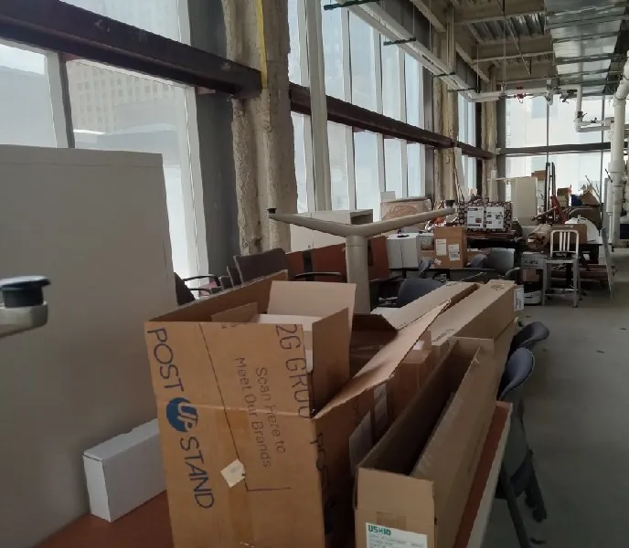 Before: more furniture and boxes along the windows (office cleanouts & office furniture removal, The Loop)