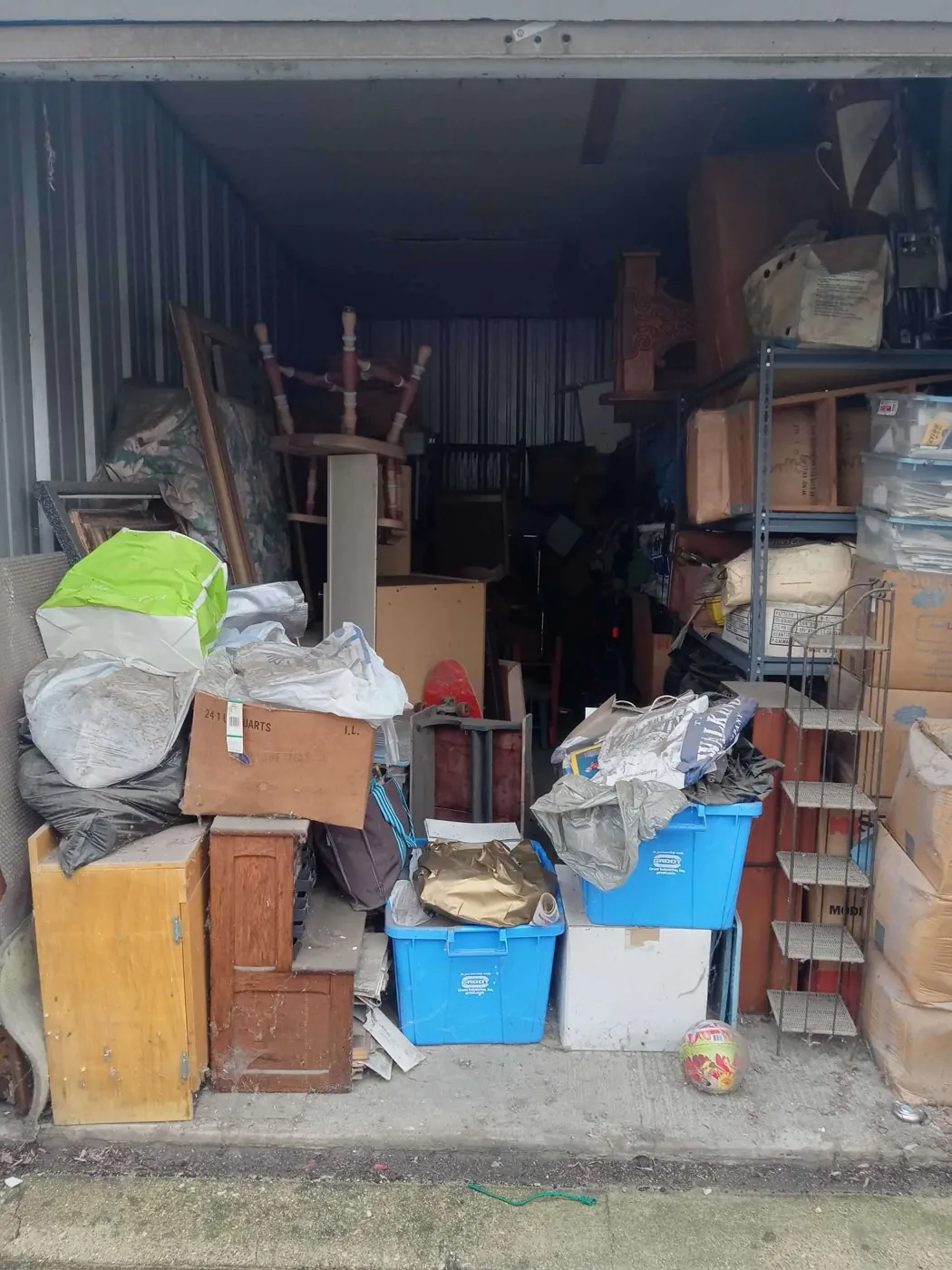 Before: second unit full of furniture and bins (storage unit cleanouts, Romeoville)