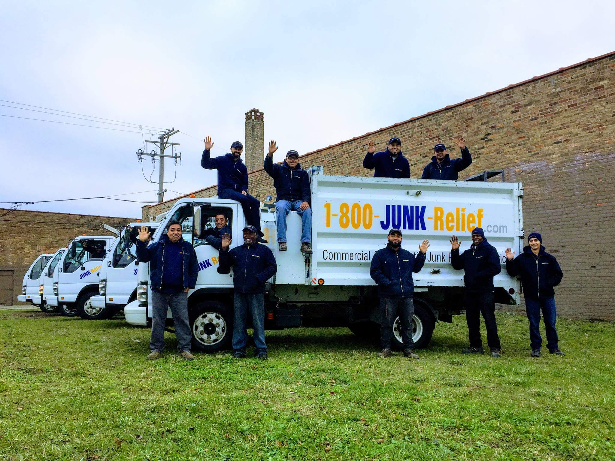 A picture of the Junk Removal Specialist team smiling and waving that helps our customers in the city of chicago and chicagoland suburbs | Junk Relief Chicago