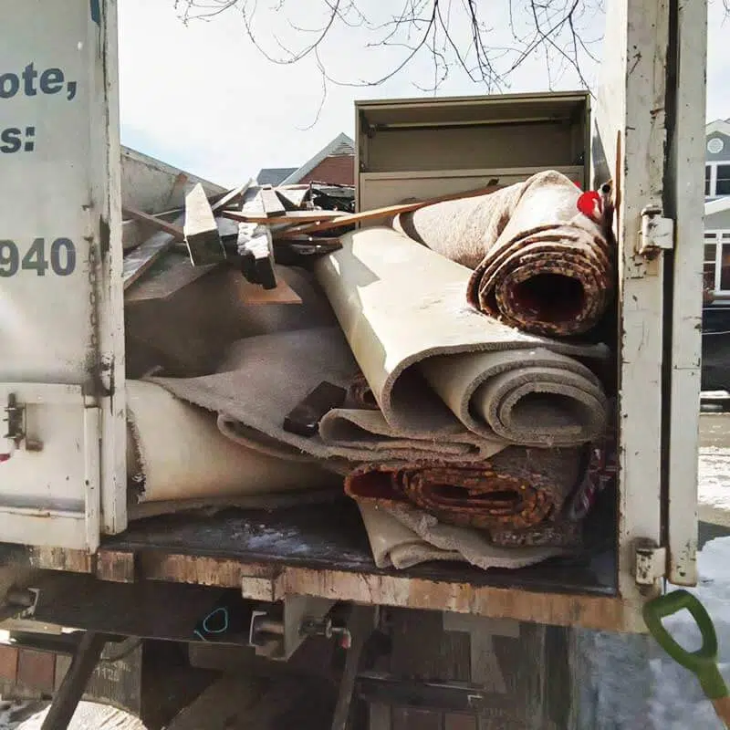 Carpet debris loaded into a junk removal truck after completing a carpet removal services project in Chicago | Junk Relief Chicago