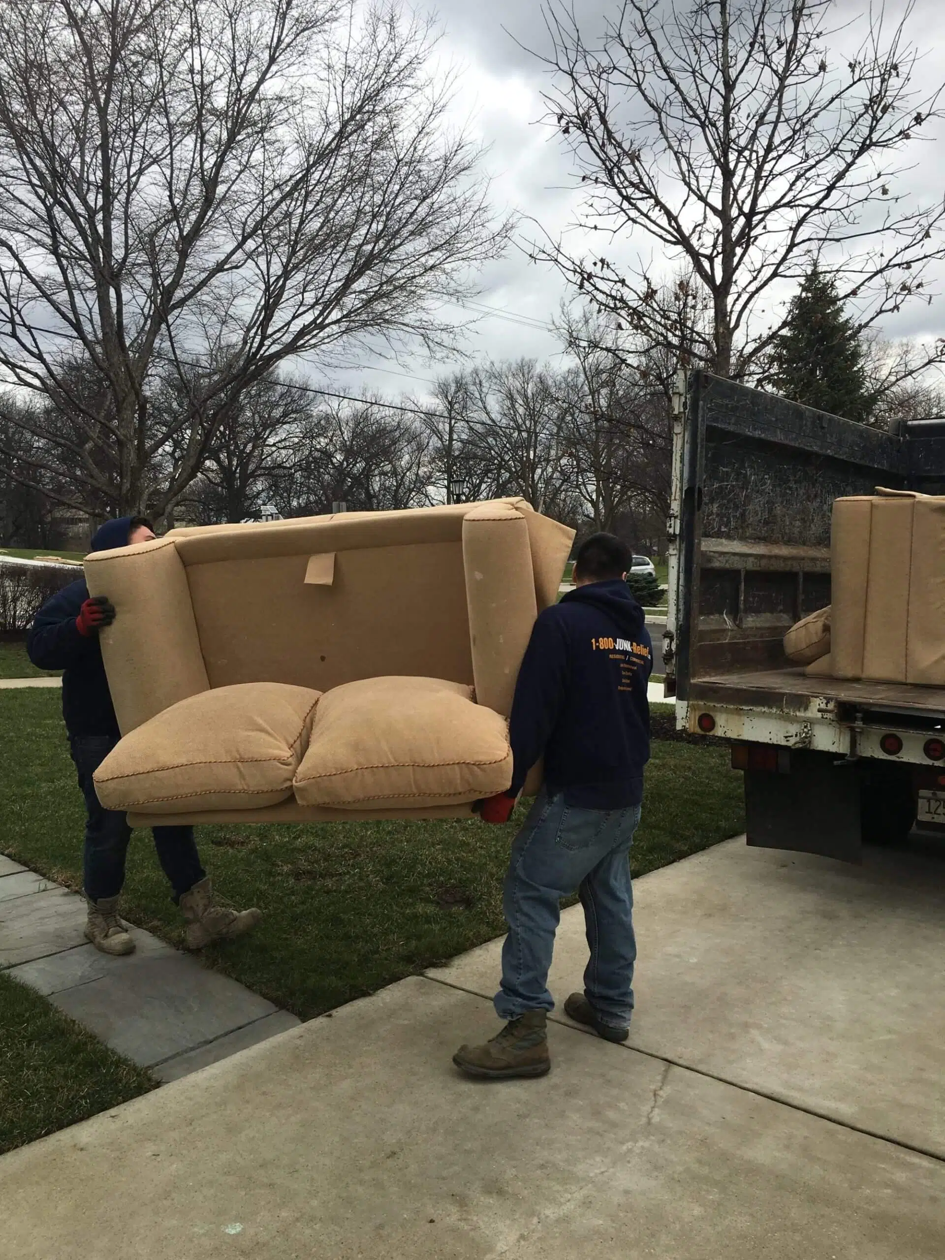 Junk Removal specialists removing a couch from a house in Chicago suburbs | Junk Relief Chicago