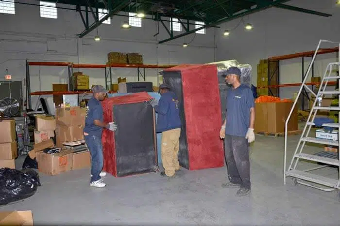 Junk Removal Specialists unloading couches and furniture for sorting, recycling, and disposal in the junk removal warehouse | JUNK Relief Chicago