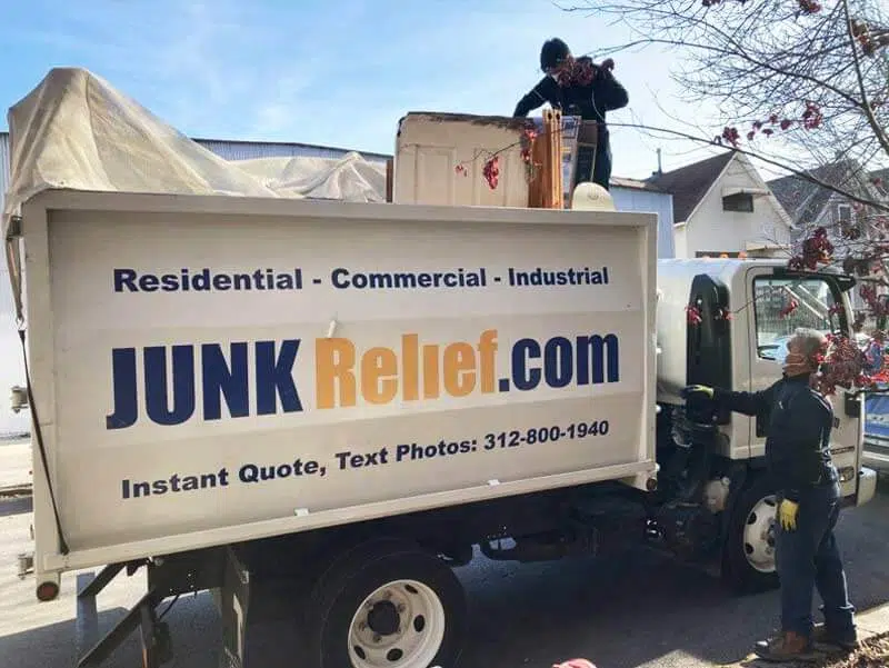 Junk removal specialists looking at a truck full of junk to accurately price out the services for the customer | Junk Relief Chicago