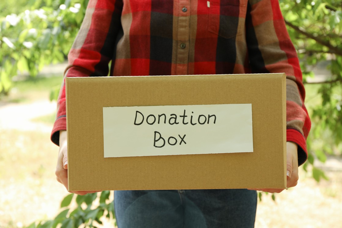 A Person Holding a Donation Box