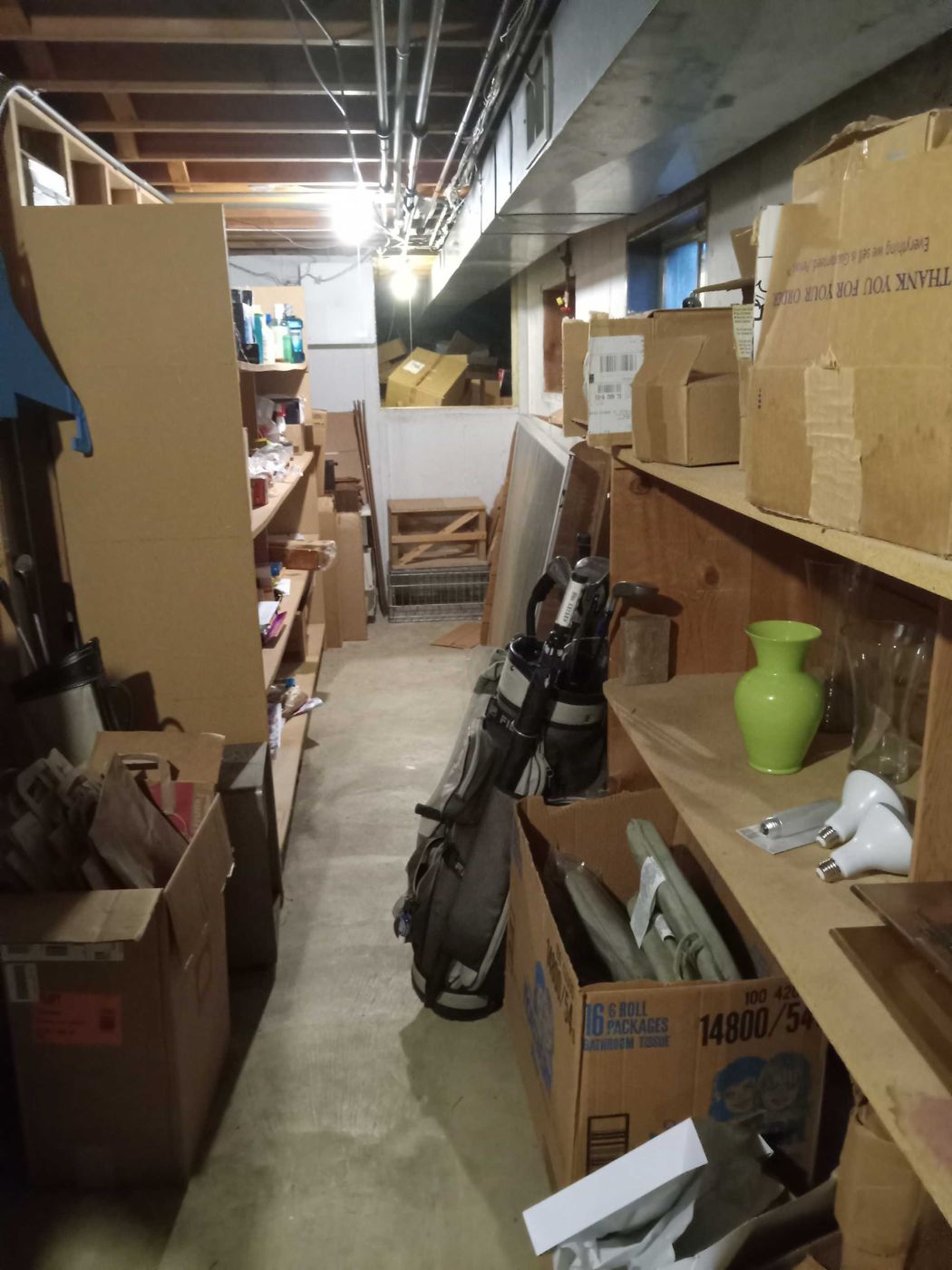 Before: the long basement aisle lined with boxes