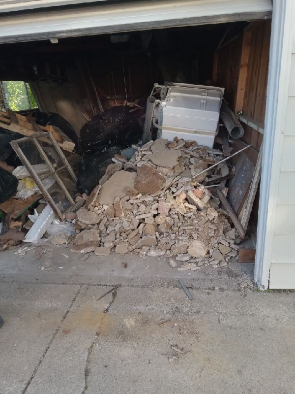 Before: broken concrete and framing spilling out of the garage door