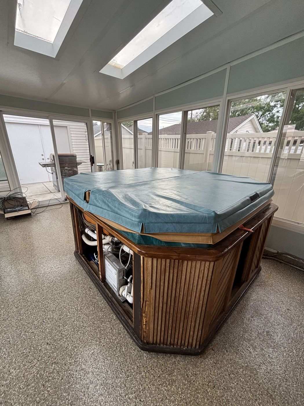 Before: the hot tub in the enclosed sunroom