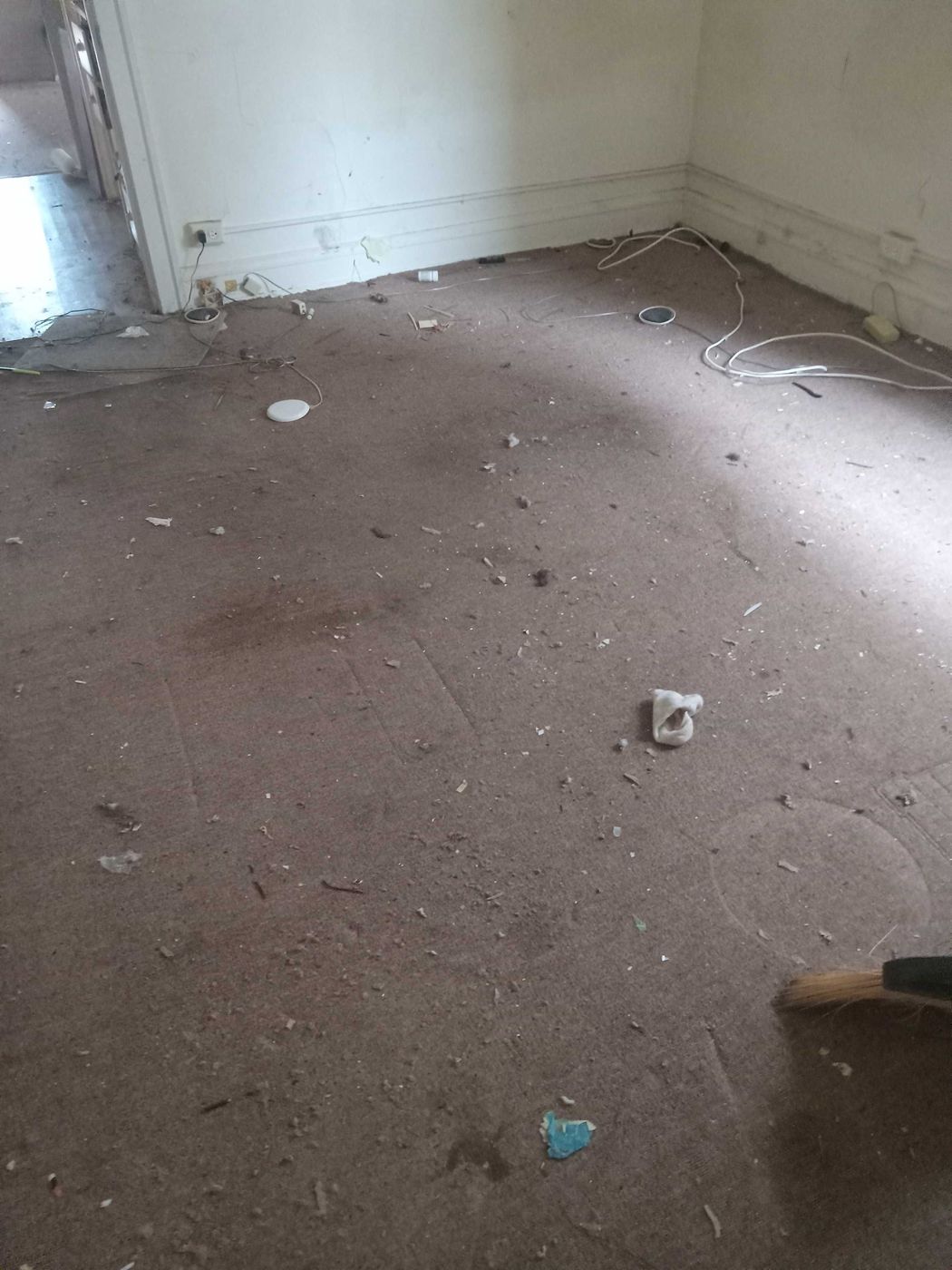 Before: worn carpet across the front room