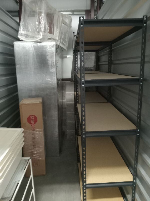 Before: shelving, shrink-wrapped furniture and boxed goods