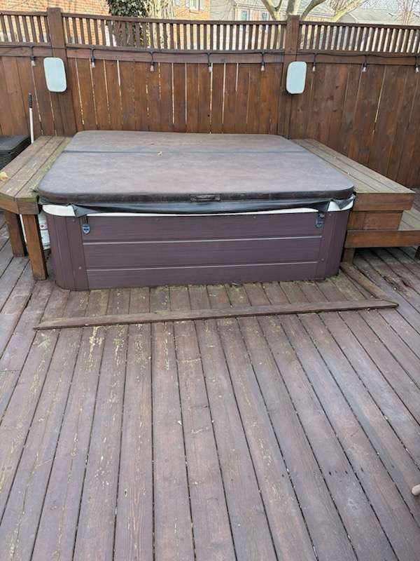 Before: the spa set into the deck against the privacy fence
